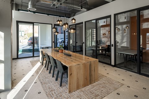 a dining room with a wooden table and chairs at The Draper, St Louis